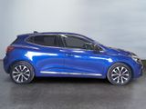 a blue car is parked in a room with a gray wall