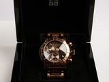 a black box with a gold watch inside of it