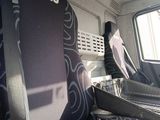 a seat in the back of a bus that is empty