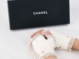 someone is holding a pair of white shoes and a black box