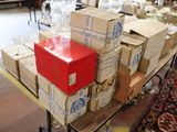 many boxes and glasses on a table with a red box