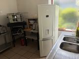 a kitchen with a sink and a refrigerator in it