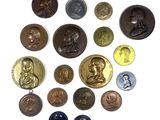 a lot of coins that are on a white surface