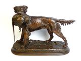 bronze statue of a dog holding a bird in its mouth
