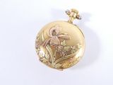 a picture of a gold pocket watch with a flower on it