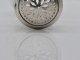 a silver salt shaker with a flower design on it