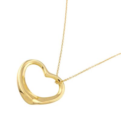 a gold heart shaped pendant with a chain on a white background