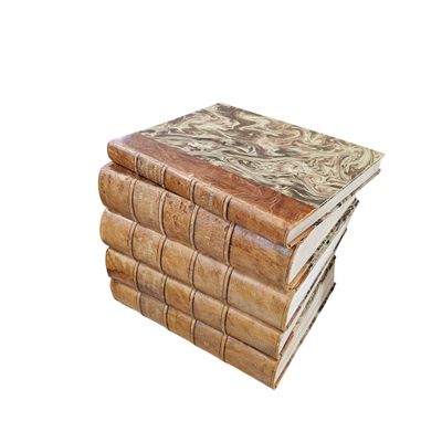 books stacked on top of each other on a white surface