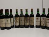 several bottles of wine are lined up on a white surface
