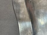 a close up of a pair of metal spoons on a table
