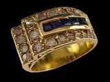 a close up of a gold ring with sapphires and diamonds
