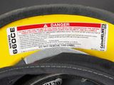 a close up of a yellow fire hydrant with a danger label on it
