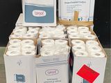 several rolls of toilet paper are stacked on a pallet in a warehouse