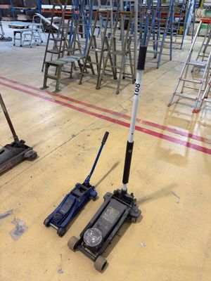 two jacks that are sitting on the floor in a warehouse