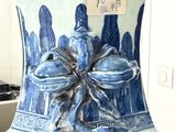 a blue and white vase sitting on a counter