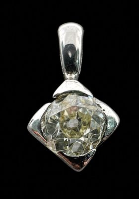 a close up of a diamond pendant on a black background