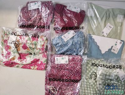 de nombreux types de vêtements, rangés dans des sacs posés sur la table