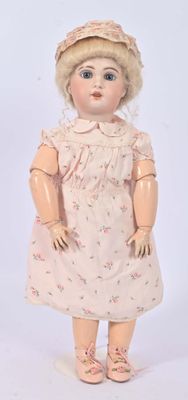 a doll that is wearing a dress and a hat