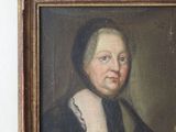 portrait of a woman holding a glass of wine in her left hand