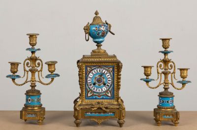 three different types of clocks sitting on a table
