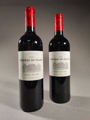 two bottles of red wine sitting next to each other