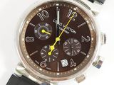 a close up of a watch with a brown face