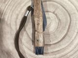a knife on a plate with a wooden handle on it