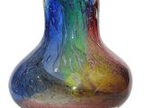 a multicolored glass vase sitting on a white surface