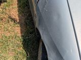 a car that is parked in the grass near other cars