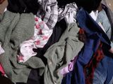 a pile of clothes that is sitting in a suitcase