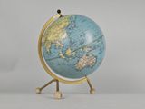 a small blue and gold globe on a stand