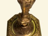 a gold candle that is sitting on top of a table