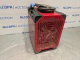 a red heater sitting on top of a table next to a wall