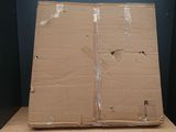a large cardboard box sitting on top of a wooden table