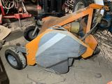a small machine that is sitting in a garage