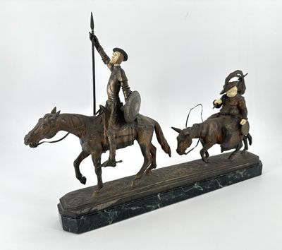 statue of a man on a horse with a spear and a man on a horse with a cow