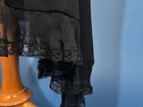 an image of a dress on a wooden stand on a blue background