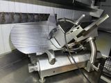 an image of a meat slicer in a commercial kitchen