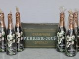 four bottles of champagne sitting on top of a table next to a box