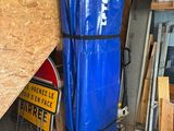 a large blue bag sitting on top of a cart in a garage