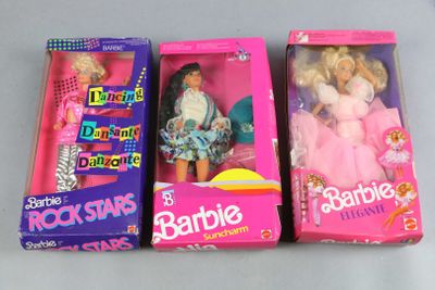 three barbie dolls are sitting in a box on a table
