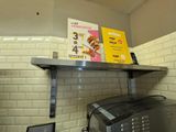 a microwave and a toaster sitting on a shelf in a kitchen