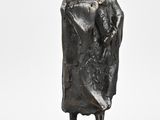 statue of a woman in a coat and hat on a marble base