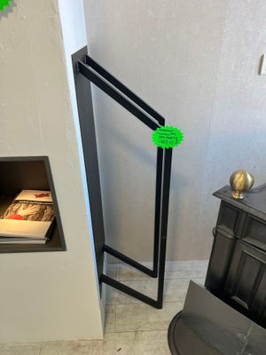 a black stove with a green sticker on it in the corner of a room