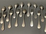 a lot of forks and spoons that are on the table