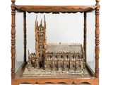 a miniature model of a cathedral in a glass case