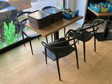 tables and chairs in a room with a fish tank in the background