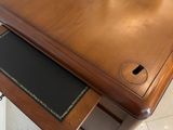 a wooden table with a glass top and a drawer underneath it