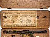 an old fashioned wooden box with brass buttons and numbers on it