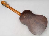 an acoustic guitar sitting on top of a white surface